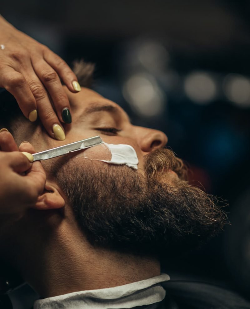 man-getting-shaved-with-straight-edge-razor-by-hai-9LJQFGR.jpg
